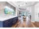 Elegant living room with hardwood floors, custom blue cabinetry, and open floor plan with water views at 4625 Foxtail Dr, Parrish, FL 34219