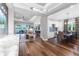 Open-concept living area with hardwood floors, views of the dining area and a lake through sliding glass doors at 4625 Foxtail Dr, Parrish, FL 34219