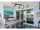 Outdoor dining area includes a built-in kitchen and sliding glass doors with water views at 4625 Foxtail Dr, Parrish, FL 34219