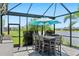 Outdoor kitchen and dining area with lake views at 4625 Foxtail Dr, Parrish, FL 34219