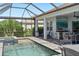 Beautiful pool, patio area with outdoor dining, an outdoor kitchen, and lake views at 4625 Foxtail Dr, Parrish, FL 34219