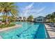Resort-style pool and clubhouse surrounded by palm trees and blue sky in luxury community of Wellen Park, Florida at 4625 Foxtail Dr, Parrish, FL 34219