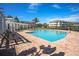 Sparkling community pool with lounge chairs and pergola under a clear blue sky at 4802 51St W St # 2010, Bradenton, FL 34210