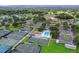 Expansive aerial view showcasing tennis courts, community pool, golf course, and clubhouse amenities at 5630 Golf Pointe Dr # 108, Sarasota, FL 34243