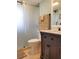 Bathroom features a vanity with marble countertop, sliding glass shower door, and neutral tile at 5630 Golf Pointe Dr # 108, Sarasota, FL 34243
