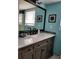 Bathroom with stylish vanity, large mirror, and decorative accents at 5630 Golf Pointe Dr # 108, Sarasota, FL 34243