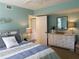 Bedroom with a stylish dresser and plenty of closet space at 5630 Golf Pointe Dr # 108, Sarasota, FL 34243