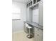 Desk/office area features gray cabinets, marble countertop, sleek white chair, and natural light at 5630 Golf Pointe Dr # 108, Sarasota, FL 34243