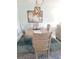 Bright dining room featuring a rustic table, chairs, modern chandelier and colorful art at 5630 Golf Pointe Dr # 108, Sarasota, FL 34243