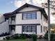 Two-story condo with brown trim, balcony, tidy landscaping, and a red tile roof on a sunny day at 5630 Golf Pointe Dr # 108, Sarasota, FL 34243