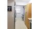 Hallway features a desk/office space with sleek gray cabinetry and a stainless steel refrigerator at 5630 Golf Pointe Dr # 108, Sarasota, FL 34243
