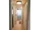Bright hallway with doorways to the bathroom, closets, and bedroom at 5630 Golf Pointe Dr # 108, Sarasota, FL 34243