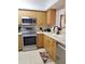Well-maintained kitchen featuring stainless steel appliances, light wood cabinets and tile flooring at 5630 Golf Pointe Dr # 108, Sarasota, FL 34243