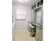 Laundry area offers ample counter space, gray cabinets, natural light, and white washer and dryer at 5630 Golf Pointe Dr # 108, Sarasota, FL 34243