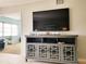 Living area with tile floors offers a gray entertainment center and bonus room in background at 5630 Golf Pointe Dr # 108, Sarasota, FL 34243