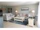 Airy living room offers neutral furnishings, tile floors, and updated lighting at 5630 Golf Pointe Dr # 108, Sarasota, FL 34243