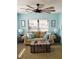 Comfortable living room with a cozy couch, rustic trunk coffee table, and modern ceiling fan at 5630 Golf Pointe Dr # 108, Sarasota, FL 34243