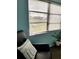Cozy living room nook with a comfortable chair, decorative pillow and view of the outdoors at 5630 Golf Pointe Dr # 108, Sarasota, FL 34243
