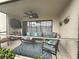 A screened-in patio with comfortable seating, a ceiling fan, and outdoor decor for a relaxing atmosphere at 5630 Golf Pointe Dr # 108, Sarasota, FL 34243