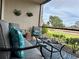 A screened-in patio offering comfortable seating and outdoor decor with views of a lush green landscape at 5630 Golf Pointe Dr # 108, Sarasota, FL 34243