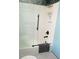 Well-lit bathroom with a modern shower and white tiled walls at 5630 Golf Pointe Dr # 108, Sarasota, FL 34243