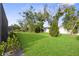 Spacious backyard features lush green lawn and mature trees at 5727 Oak Bridge Ct, Bradenton, FL 34211