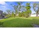 Expansive backyard showcasing lush lawn, mature trees, and serene outdoor space at 5727 Oak Bridge Ct, Bradenton, FL 34211
