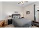Cozy bedroom featuring a comfortable bed, dark nightstand, and ceiling fan at 5727 Oak Bridge Ct, Bradenton, FL 34211