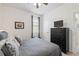 Comfortable bedroom featuring neutral walls, double closets, ceiling fan, and modern decor at 5727 Oak Bridge Ct, Bradenton, FL 34211