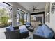 Well-furnished covered patio with a ceiling fan, offering comfortable seating and clear views of the backyard at 5727 Oak Bridge Ct, Bradenton, FL 34211