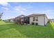 Well-maintained home featuring a screened-in porch and a lush green lawn at 5727 Oak Bridge Ct, Bradenton, FL 34211