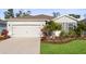 Charming single-story home features a well-manicured lawn and a two car garage at 5727 Oak Bridge Ct, Bradenton, FL 34211