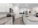 Bright kitchen with stainless steel appliances, granite countertops, and white cabinets at 5727 Oak Bridge Ct, Bradenton, FL 34211