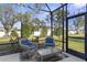 Relaxing screened-in porch with comfortable seating and clear views of the landscaped backyard at 5727 Oak Bridge Ct, Bradenton, FL 34211