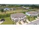 Aerial view showcases the property's layout, landscaping, and proximity to nearby gardens at 633 Royal Empress Dr, Ruskin, FL 33570