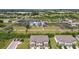 Aerial perspective of a townhome complex near gardens with lush greenery and clear skies at 633 Royal Empress Dr, Ruskin, FL 33570