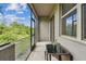Enjoy the serene screened-in patio with a view to natural green surroundings and a small outdoor table at 633 Royal Empress Dr, Ruskin, FL 33570