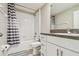 Bathroom featuring a shower-tub combo and vanity with granite countertop at 633 Royal Empress Dr, Ruskin, FL 33570