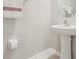 Clean half bathroom features a pedestal sink and neutral decor at 633 Royal Empress Dr, Ruskin, FL 33570