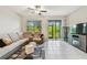 Spacious living room features modern furniture, tiled floors and view of the outdoors at 633 Royal Empress Dr, Ruskin, FL 33570