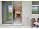 View from the patio through sliding glass door to the staircase and interior living space at 633 Royal Empress Dr, Ruskin, FL 33570