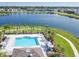 Community pool and lake offer picturesque views, seating, and shade umbrellas for residents at 633 Royal Empress Dr, Ruskin, FL 33570