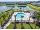 Enjoy the sunshine at the community pool with palm trees, lounge chairs, and scenic lake views at 633 Royal Empress Dr, Ruskin, FL 33570