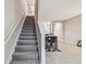 Carpeted staircase leading to the upper level with a view of the open living area at 633 Royal Empress Dr, Ruskin, FL 33570
