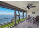 Relaxing screened balcony offers seating, ceiling fan, and panoramic waterfront views at 6500 Flotilla Dr # 125, Holmes Beach, FL 34217