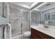 Bright bathroom featuring a glass shower, wood vanity, and matching towel rack at 6500 Flotilla Dr # 125, Holmes Beach, FL 34217