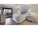 Bright bedroom featuring tiled floors, a ceiling fan, and sliding glass doors to a balcony at 6500 Flotilla Dr # 125, Holmes Beach, FL 34217