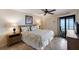 Inviting bedroom with a plush bed, comfortable decor, and sliding door access to a private waterfront balcony at 6500 Flotilla Dr # 125, Holmes Beach, FL 34217