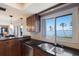 Bright kitchen featuring dark granite countertops, stainless steel appliances, and a beautiful water view from the window at 6500 Flotilla Dr # 125, Holmes Beach, FL 34217