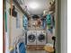 Efficient laundry room equipped with washer, dryer, and ample storage shelving at 6500 Flotilla Dr # 125, Holmes Beach, FL 34217